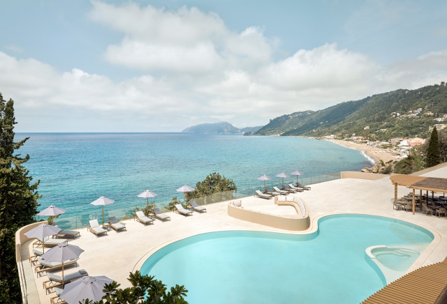 hotel swimming pool in corfu with the sea beyond