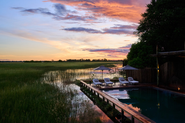 pool area at sediba sa rona with the sun setting in the distance