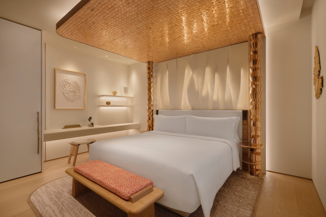 one-bedroom suite with poster bed in gold tones