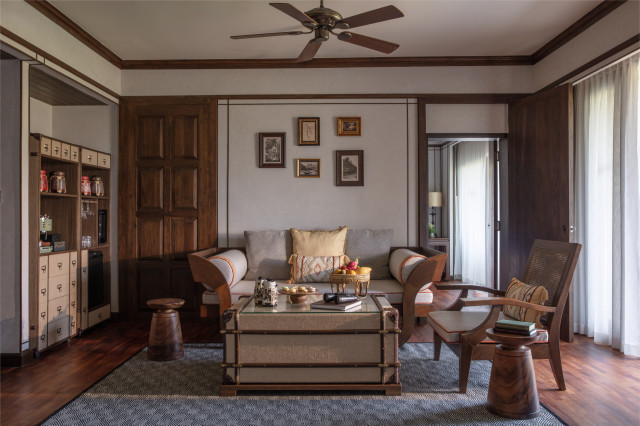 lounge area inside hotel suite with sofa and armchair