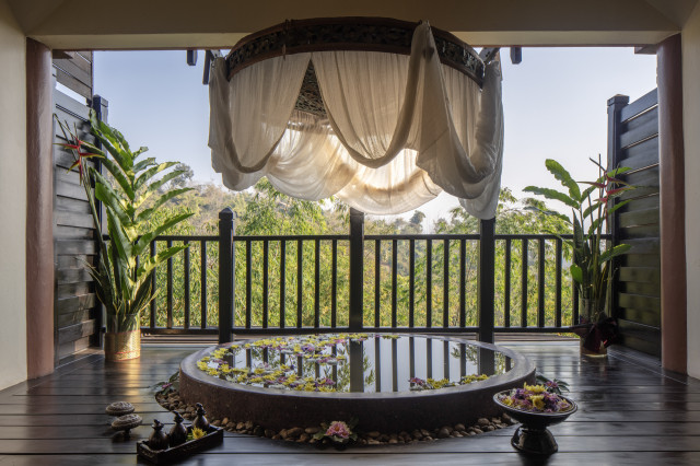 water feature on hotel balcony with an awning above it