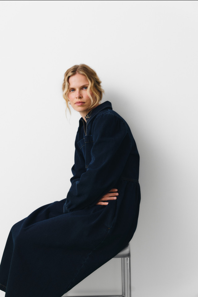 model posing in deep blue denim dress