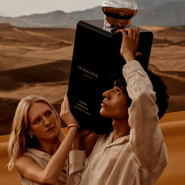 two models posing with oversized bottle of Jo Malone perfume
