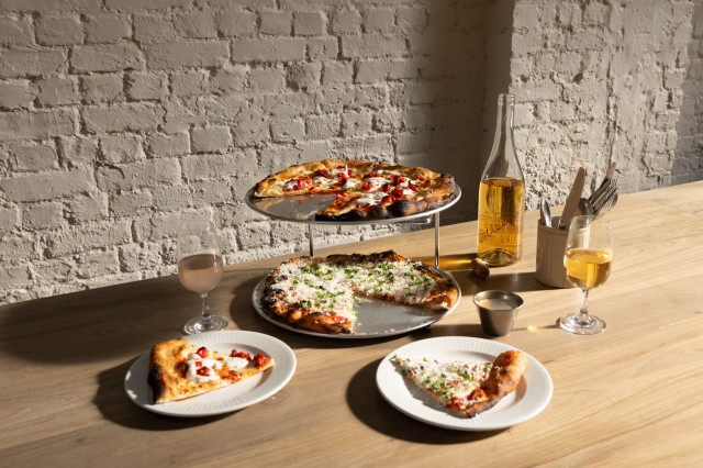 pizzas served with glasses of wine