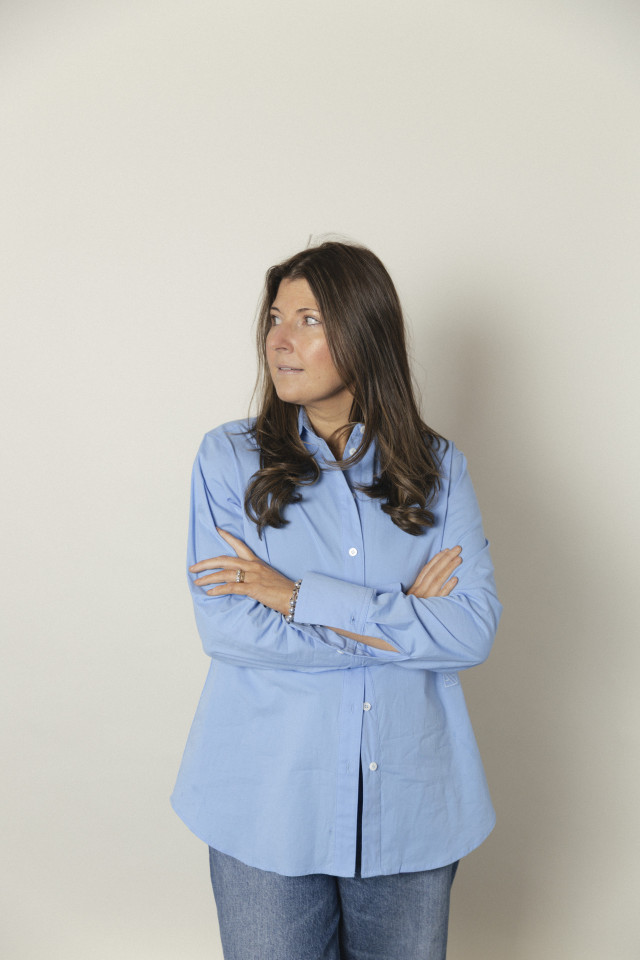ginny seymour posing in tailored sky blue shirt