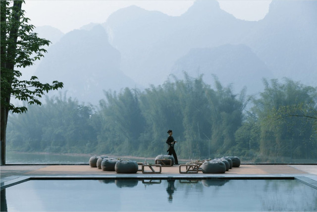 hotel pool with trees in the background