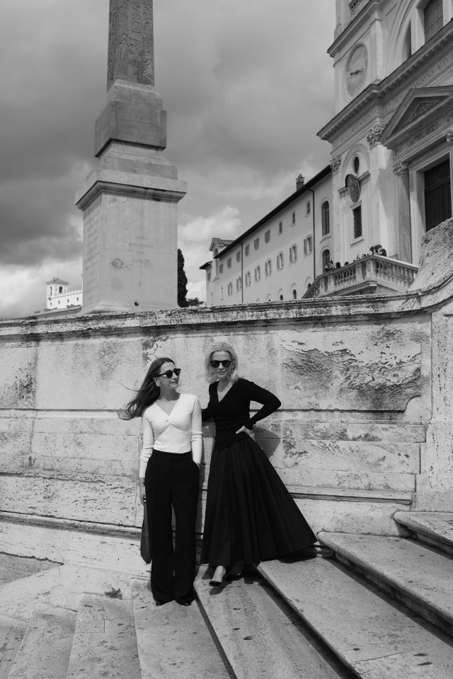 mother and daughter posing on stone steps