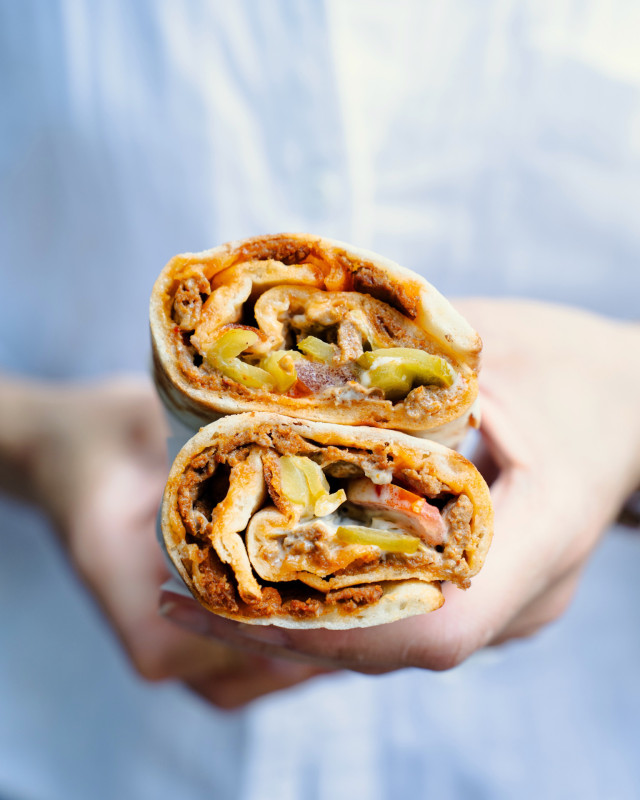 person holding a wrap cut in half