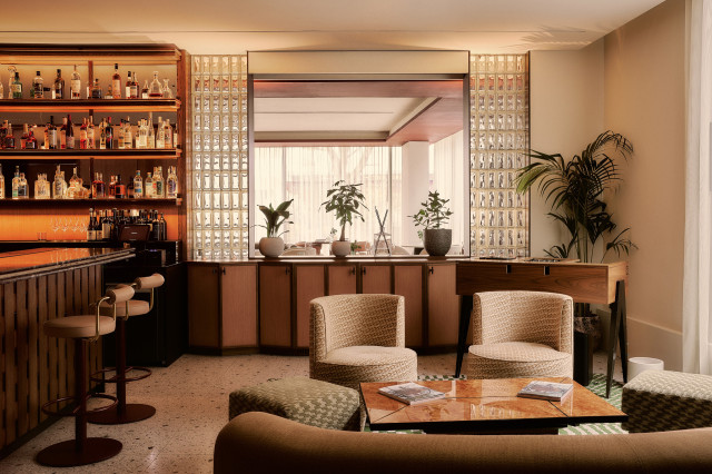 interiors of aethos with curved sofa, chairs, and bar area