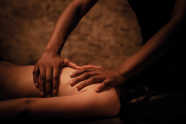 woman inside spa getting back massage 