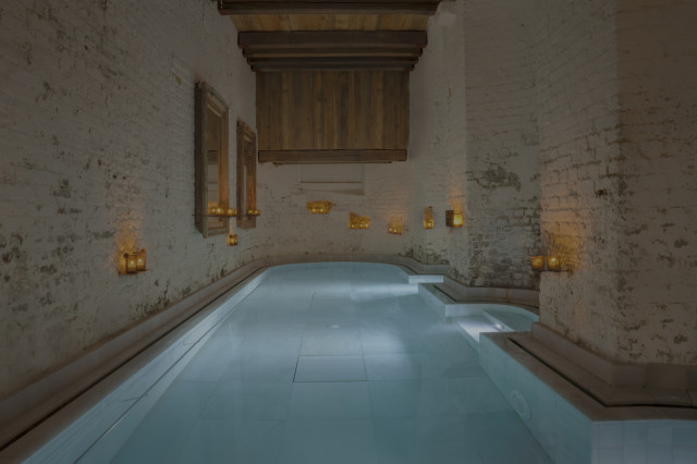 pool in spa surrounded by small candles