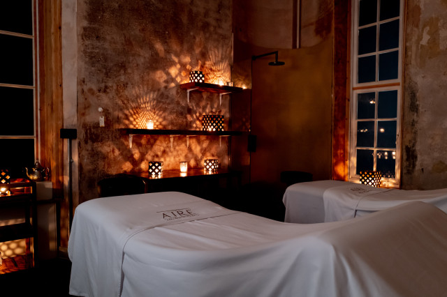 treatment room inside spa with two beds and candles