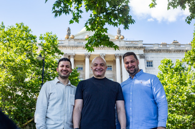 three people posing in front of somerset house