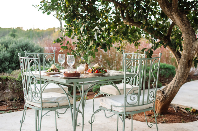 restaurant in ibiza with tables and chairs outside 
