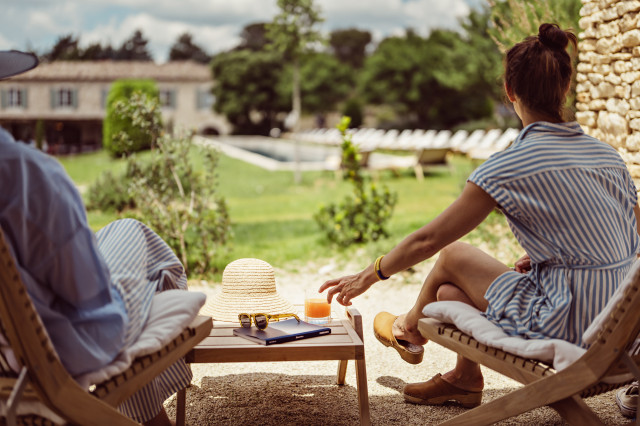 two people relaxing on deck chairs at hotel in France