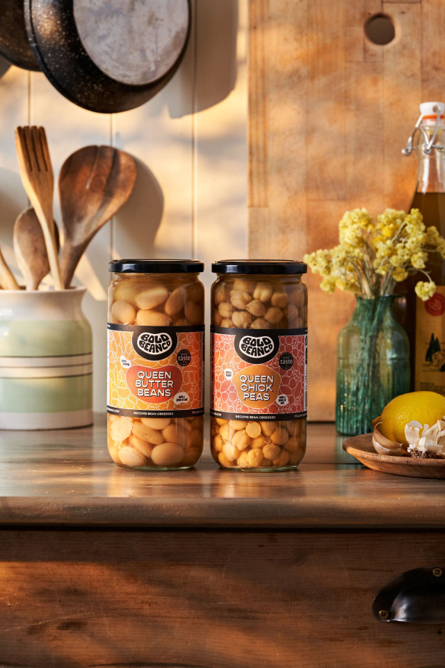 two jars of beans on wooden table