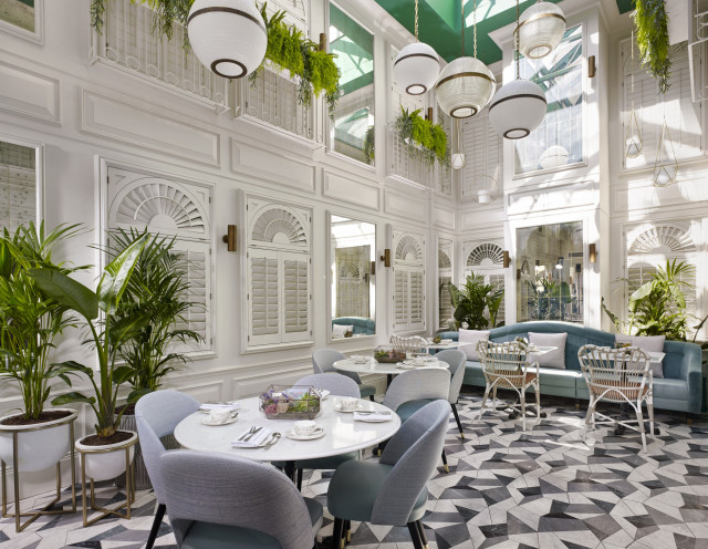 atrium with round tables, plants and hanging lights