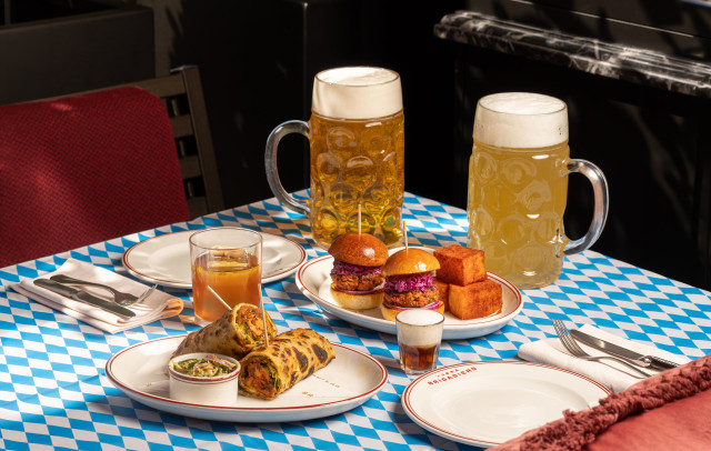 two pints of beer alongside sliders and wraps 