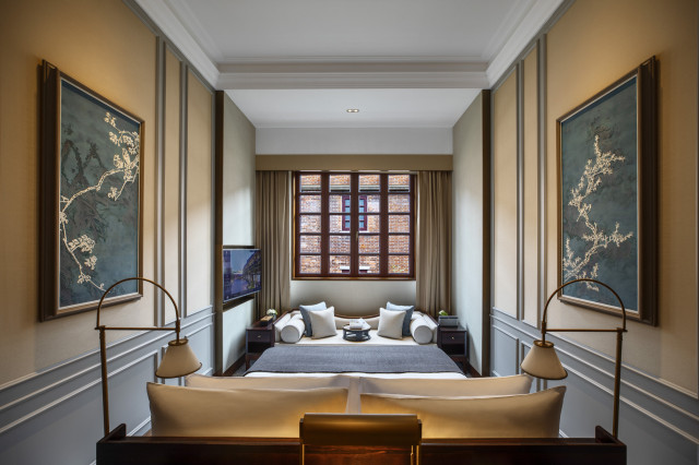 hotel bedroom with framed art on the walls