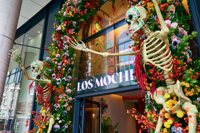 los mochis restaurant front with floral display and plastic skeletons