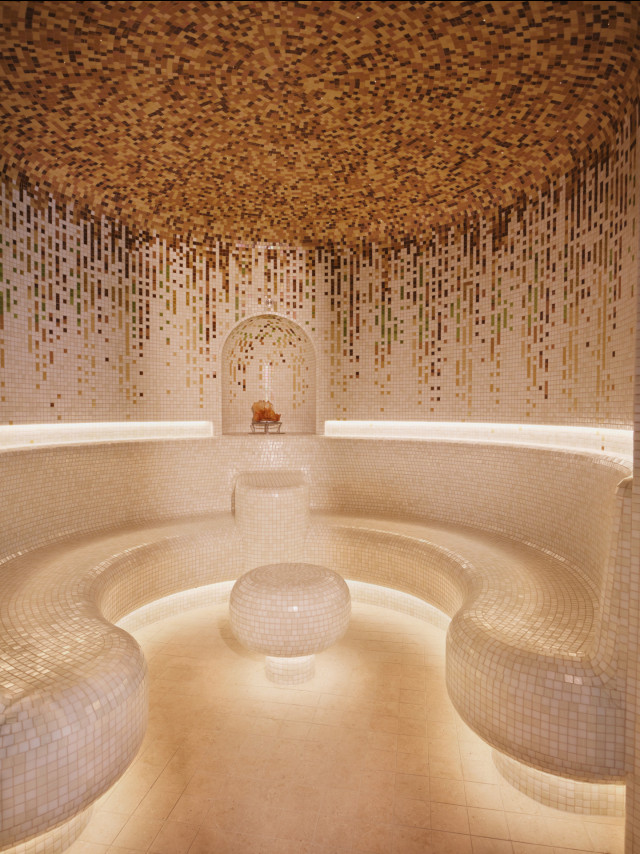 steam room with cream tiles 