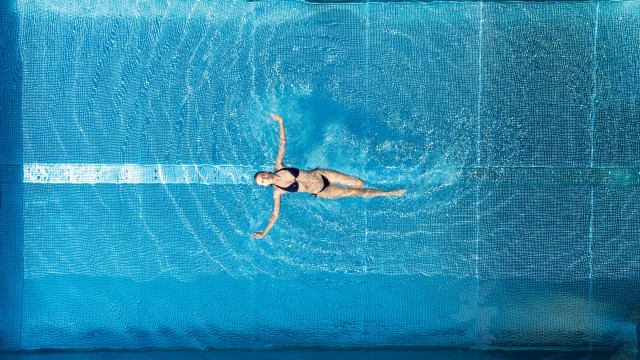person floating in swimming pool
