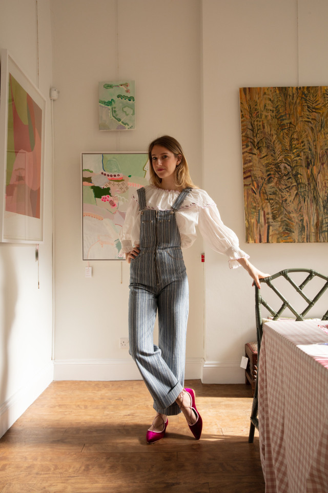 woman posing surrounded by artwork
