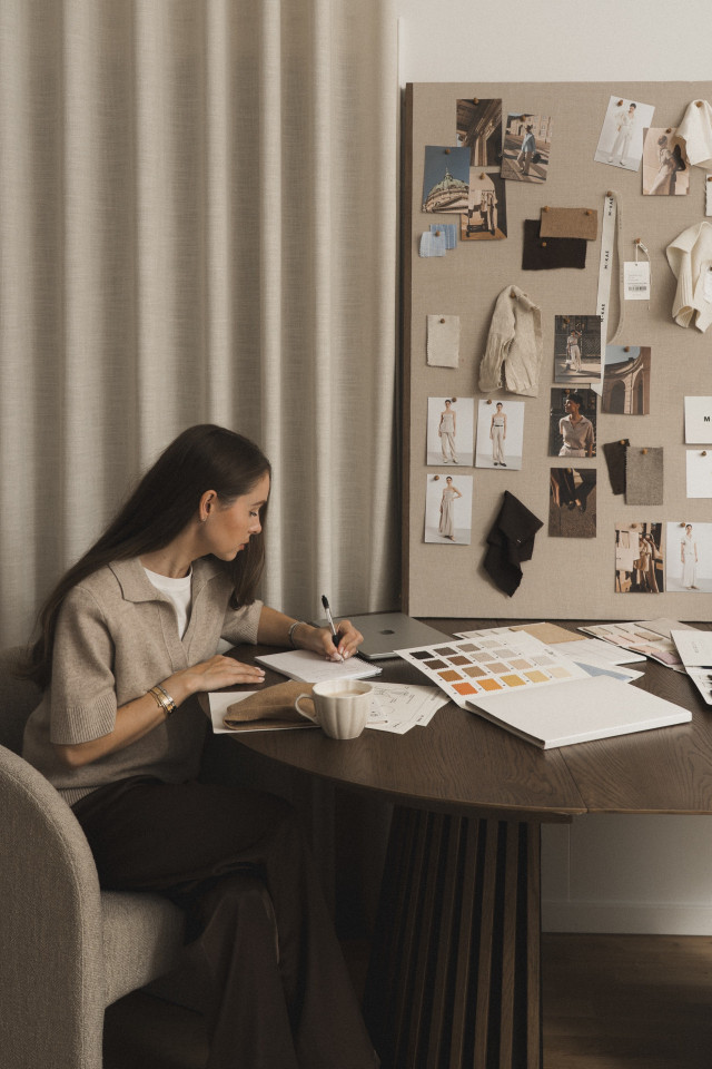 fashion designer writing down notes at table 