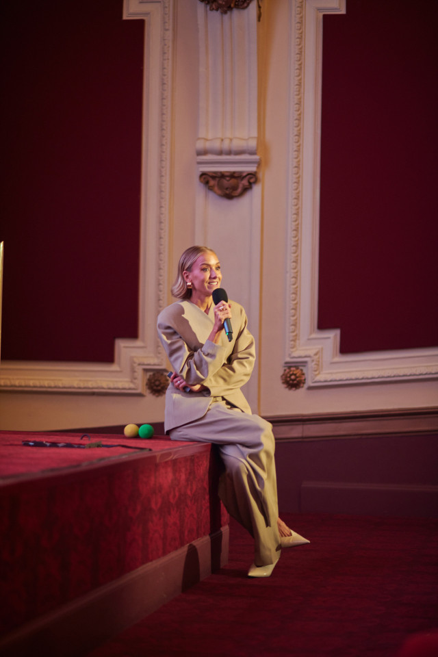 hermione olivia giving a talk in a theatre
