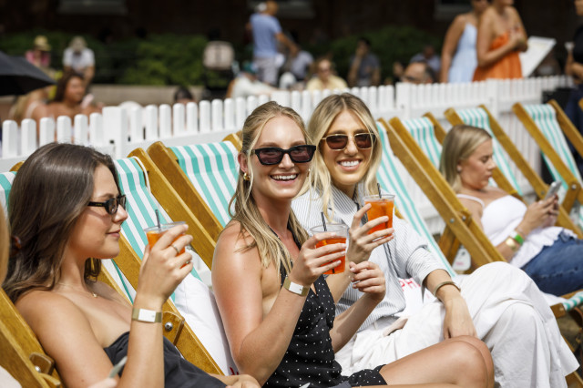 group of people watching big screen in deckchairs