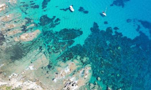 Aerial view of blue sea with some boats.
