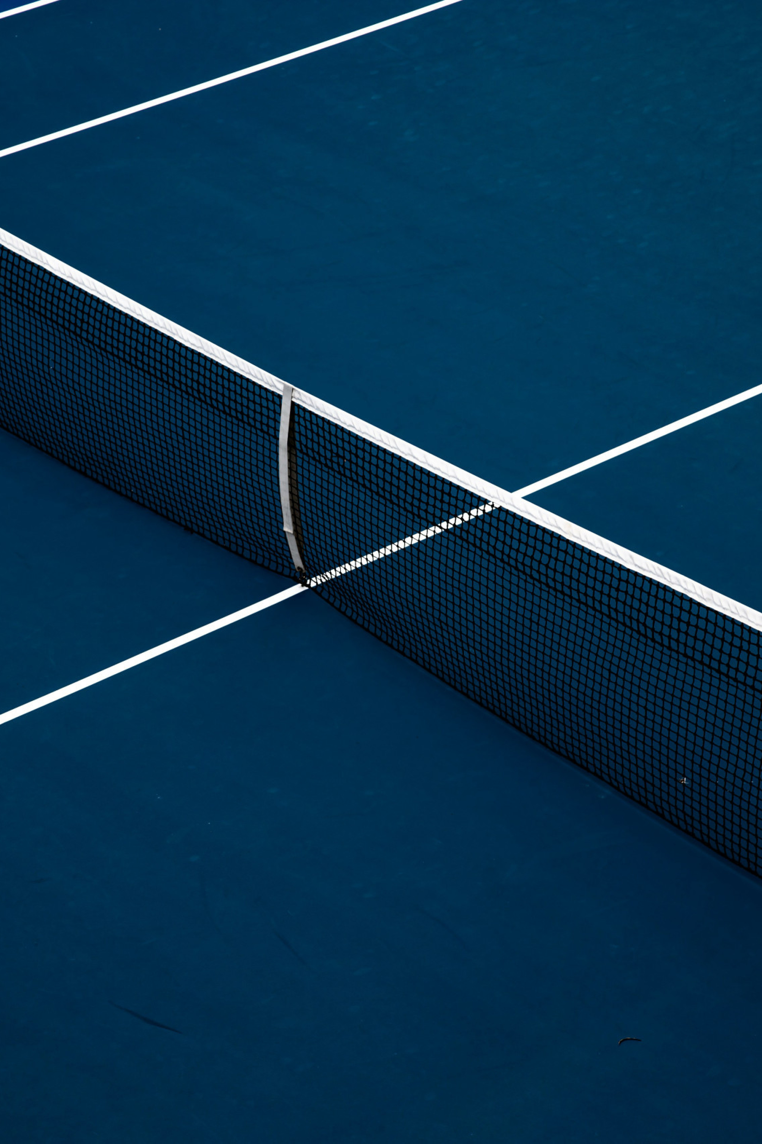 blue tennis court with net set up