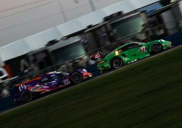 Cars racing on the Daytona International Speedway.