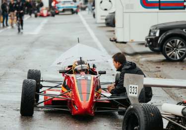 Red race car on a wet track.