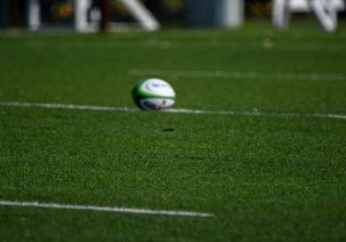 Blurry rugby ball on a field.