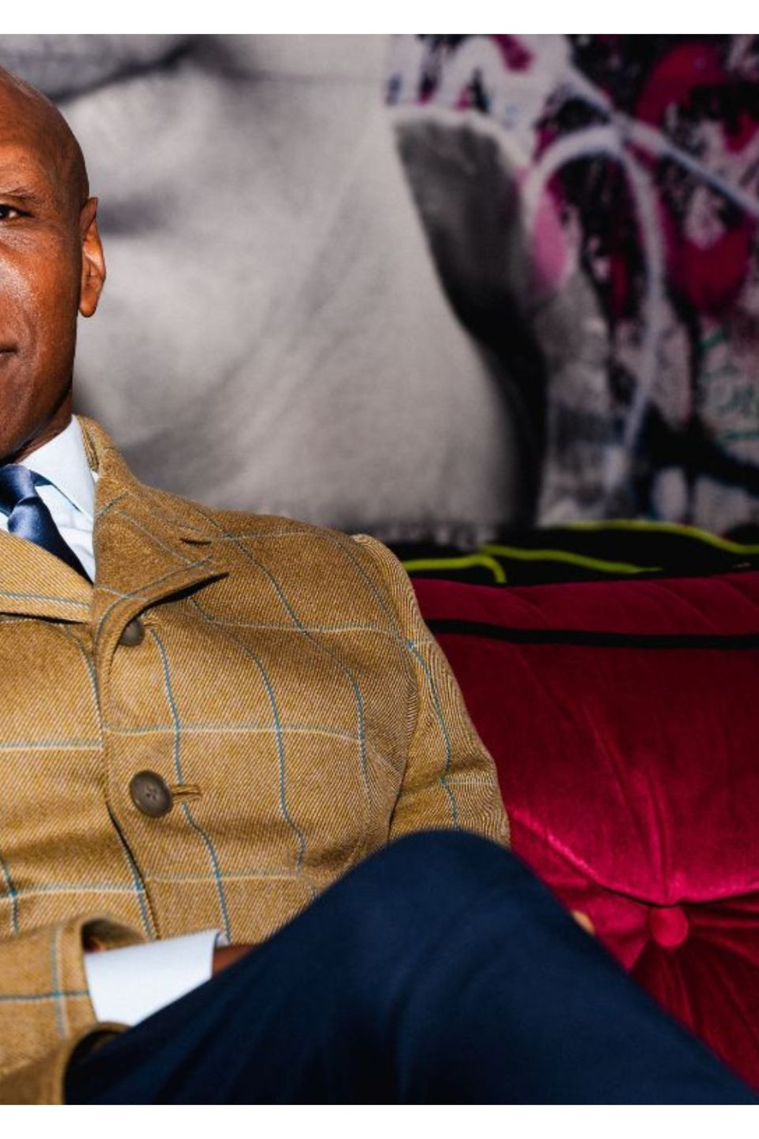 photo of chris eubank on red velvet sofa 