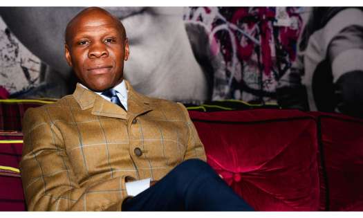 Photo of chris eubank on red velvet sofa .