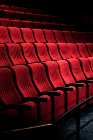 Red seating inside private cinema.