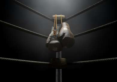 Pair of boxing gloves in boxing ring .