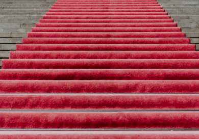 Staircase with red carpet on it .