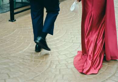 Couple dressed smartly walking to event.
