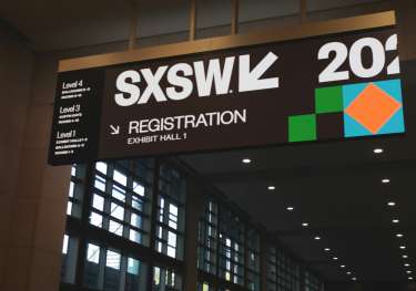 SXSW registration sign above a hallway.