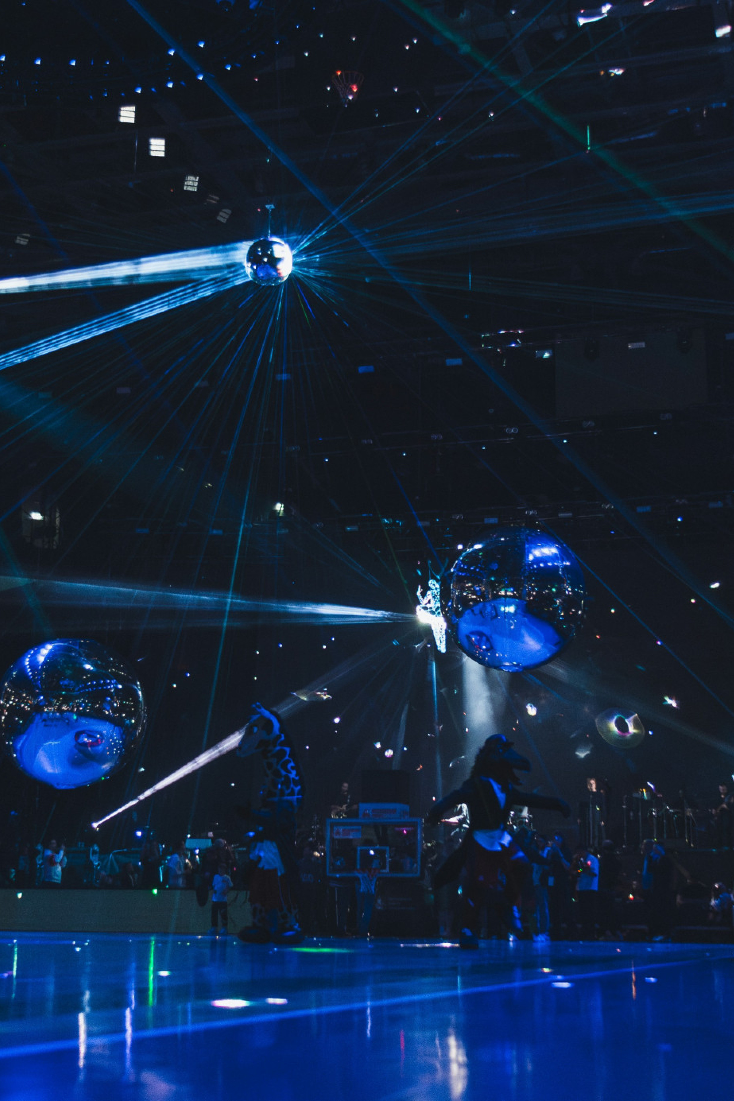 2025 Eurovision Song Contest Grand Final with dark blue lighting, 4 large mirror balls, and 1 disco ball.