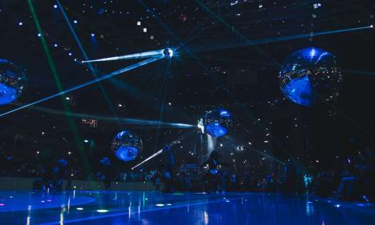 2025 Eurovision Song Contest Grand Final with dark blue lighting, 4 large mirror balls, and 1 disco ball.