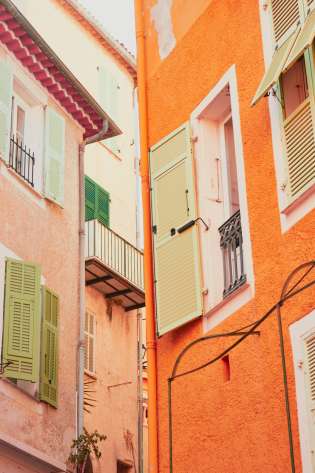 Photo of orange and coral houses in a French town.