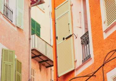 Photo of orange and coral houses in a French town.