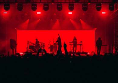 Band on stage with red lighting.