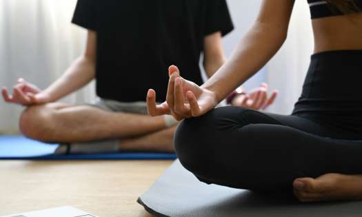Two people doing yoga.
