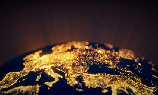 Globe of Earth lit up at night on land.