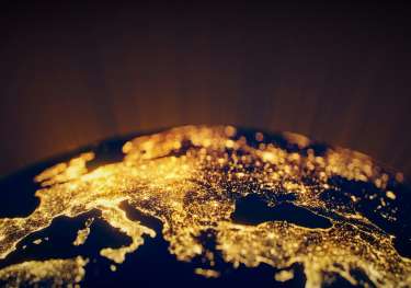 Globe of Earth lit up at night on land.